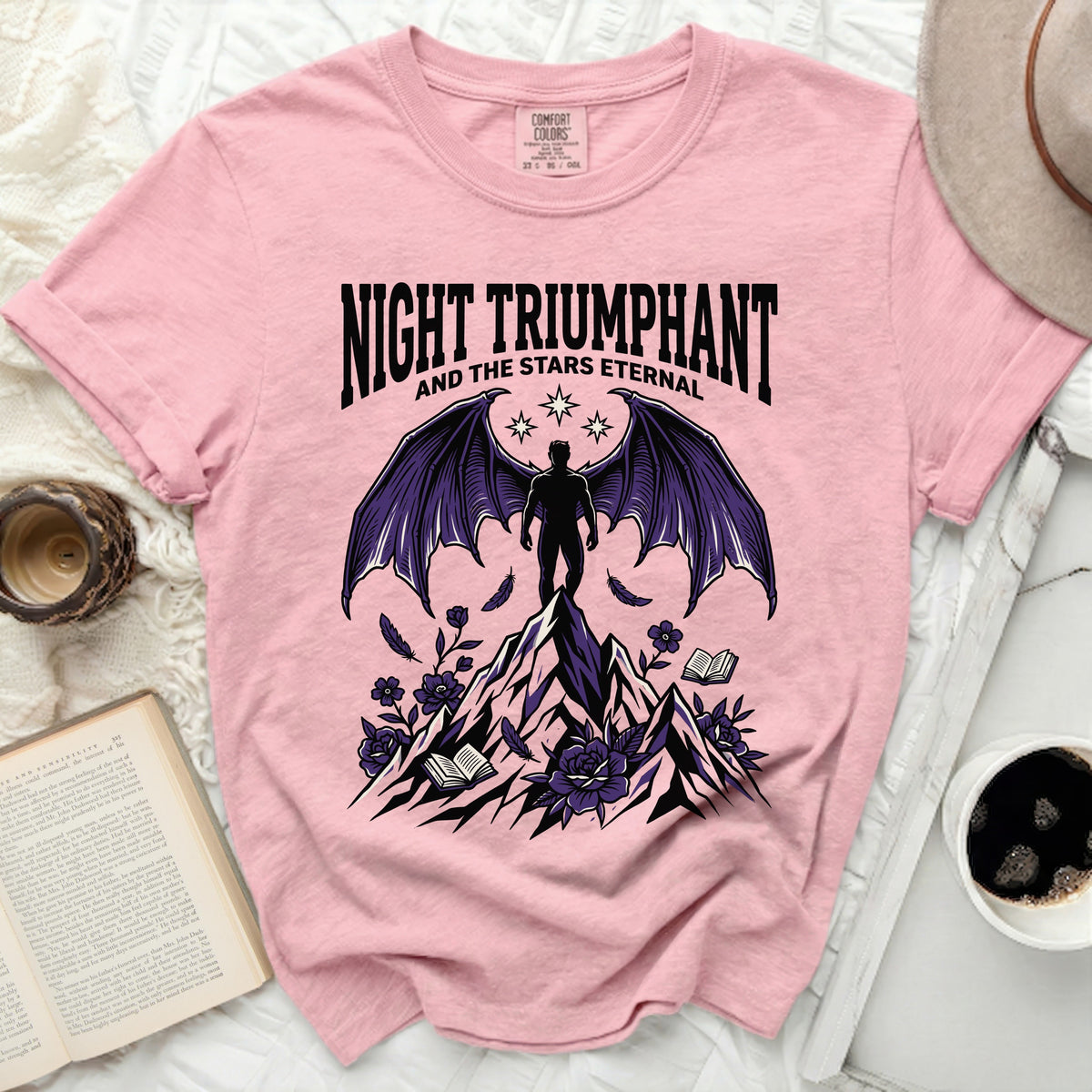Pink t-shirt with "Night Triumphant and the Stars Eternal" graphic.