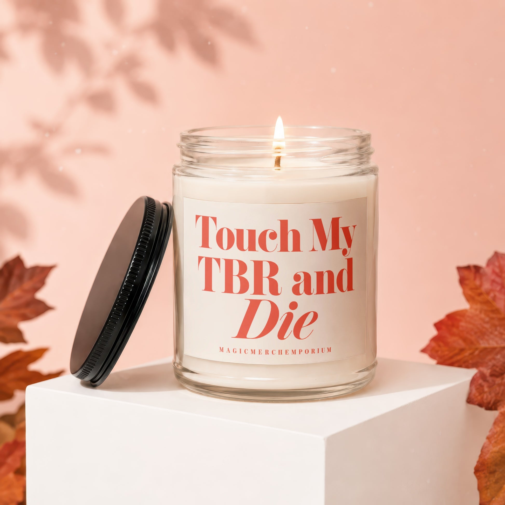 Glass candle with lid off reads "Touch My TBR and Die."