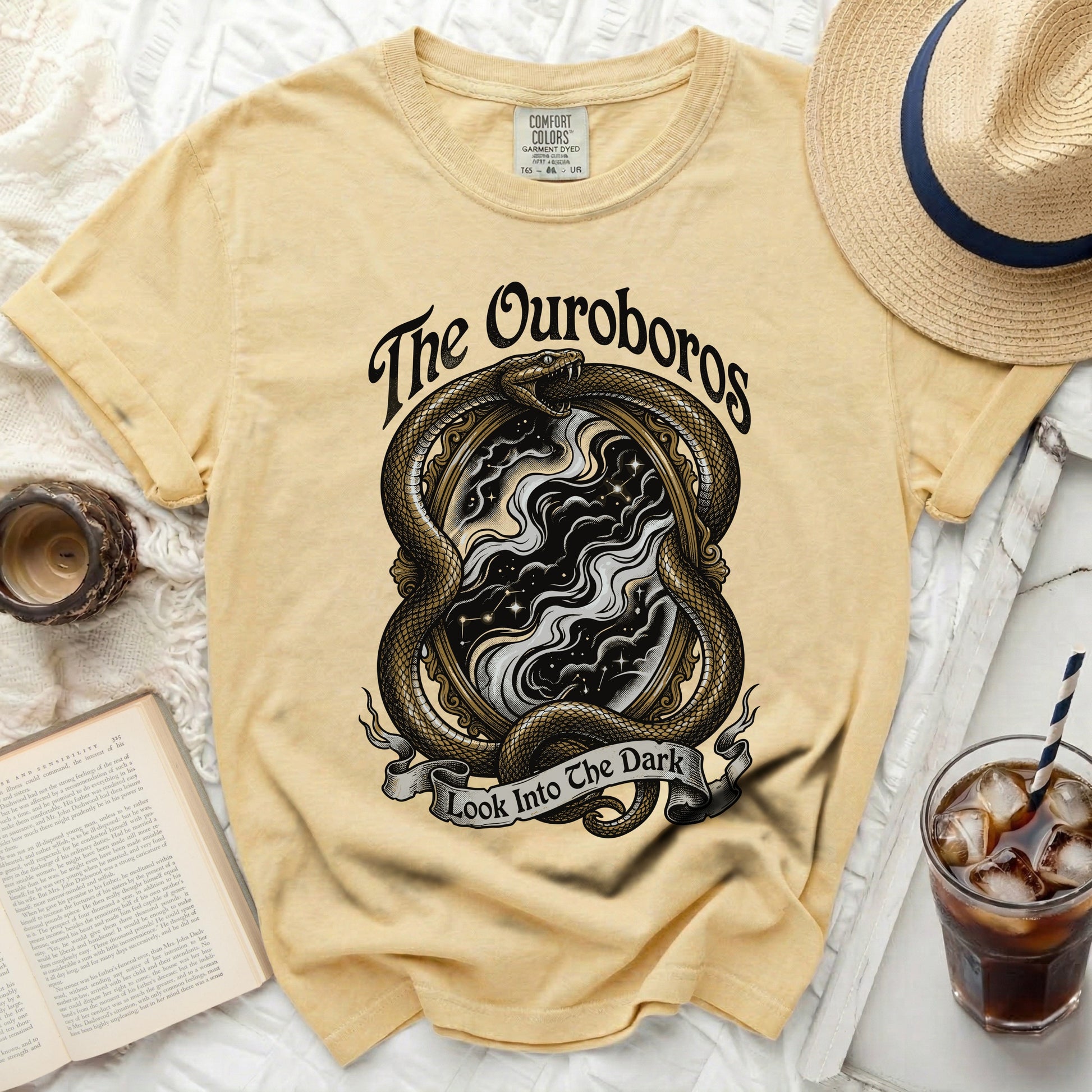 Yellow t-shirt with an ouroboros snake encircling a mirror with starry sky and text.
