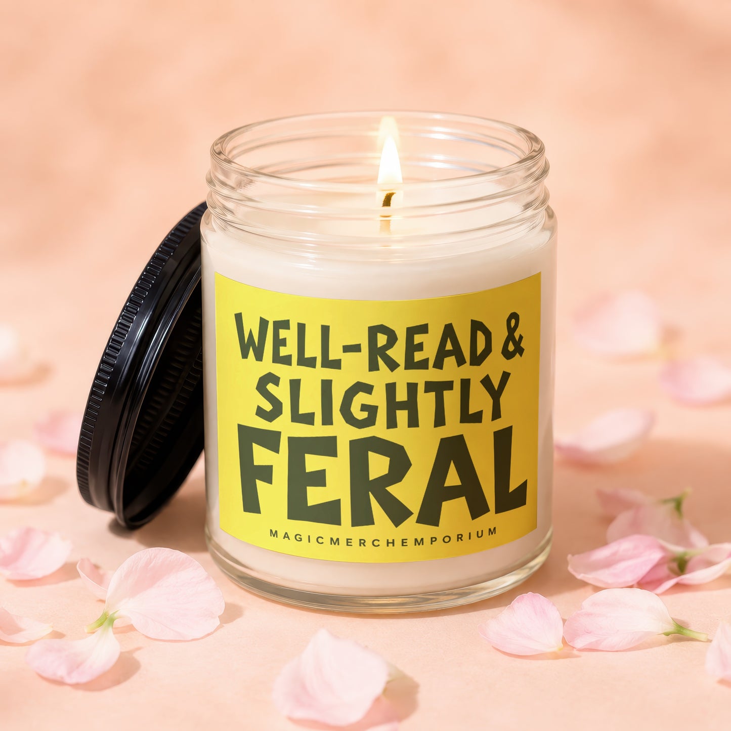 Candle with "Well-Read & Slightly Feral" text on yellow label, lid off.