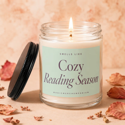 Candle labeled "Smells Like Cozy Reading Season" with a lit wick