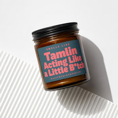 Amber jar candle with black lid, reads "Smells Like Tamlin Acting Like a Little B*tch".