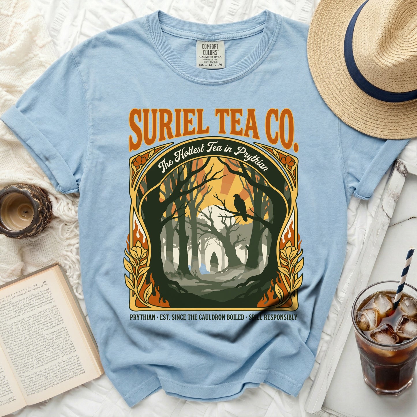 Light blue t-shirt with "SURIEL TEA CO. The Hottest Tea in Prythian" graphic.