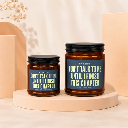 Two brown glass candles with blue labels stating "Don't talk to me until I finish this chapter".