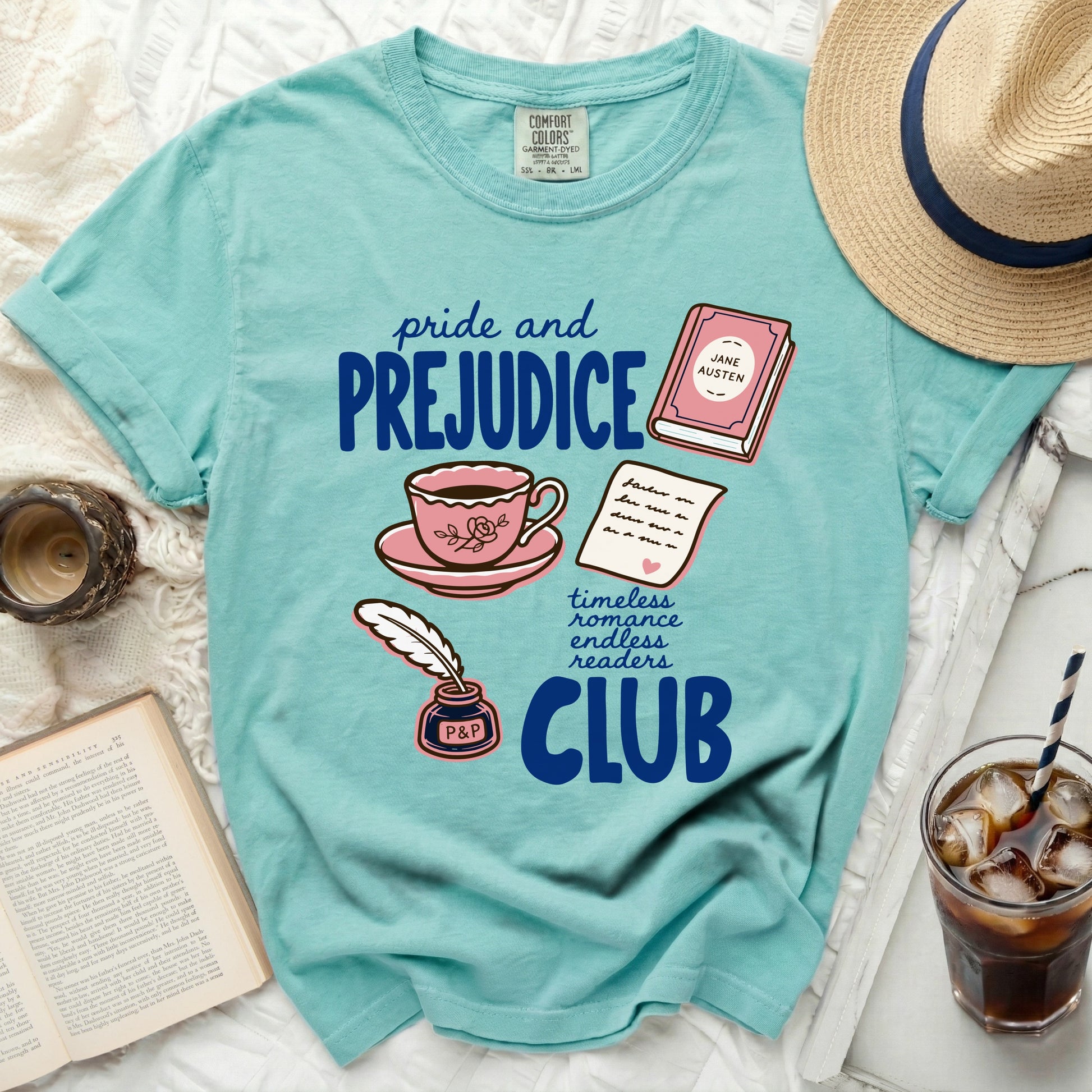 Teal t-shirt with "Pride and Prejudice Club" graphic, book, teacup, and feather quill.