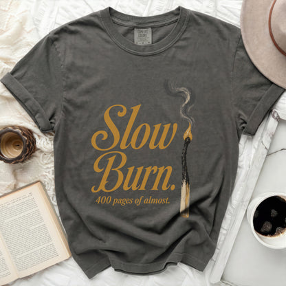 Grey t-shirt with "Slow Burn. 400 pages of almost." text and burnt match.