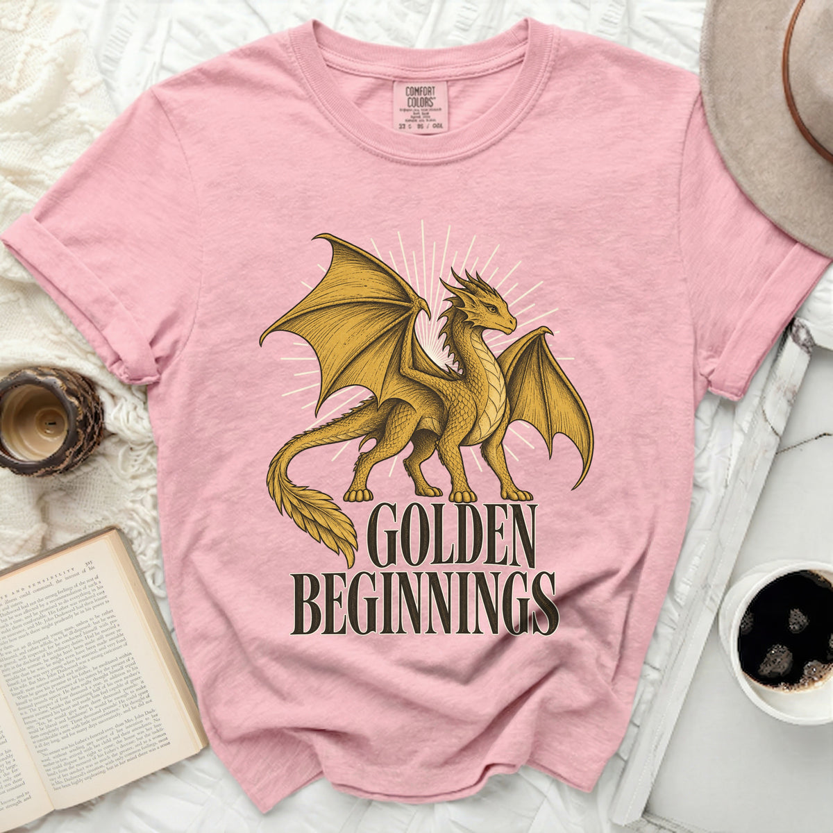Pink t-shirt with a golden dragon graphic and text "GOLDEN BEGINNINGS".