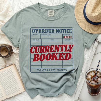T-shirt with "OVERDUE NOTICE CURRENTLY BOOKED PLEASE DO NOT DISTURB" graphic.