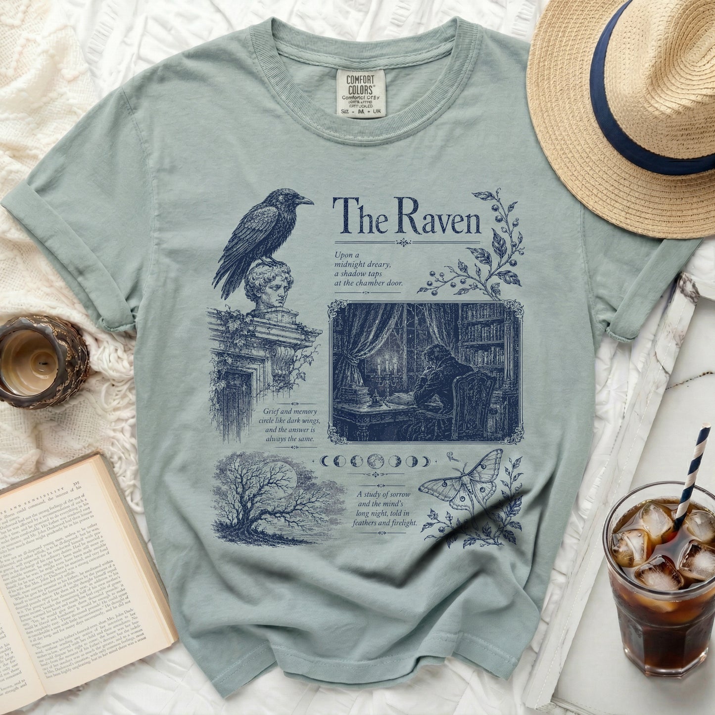T-shirt with dark blue "The Raven" design featuring a raven, bust, library scene, and text.