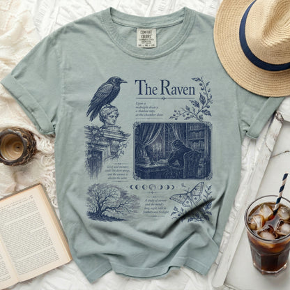T-shirt with dark blue "The Raven" design featuring a raven, bust, library scene, and text.