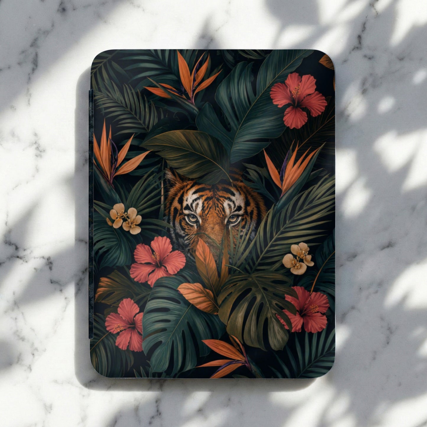 Journal with tiger face and tropical flowers and leaves in a dark jungle setting.