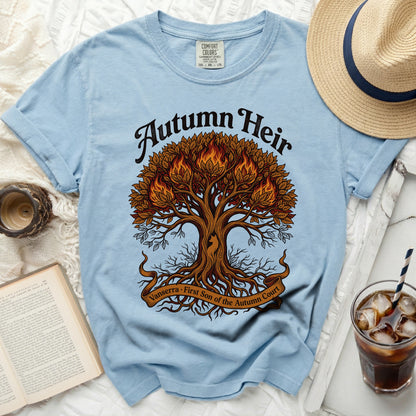 Light blue t-shirt with "Autumn Heir" and a fiery tree graphic.