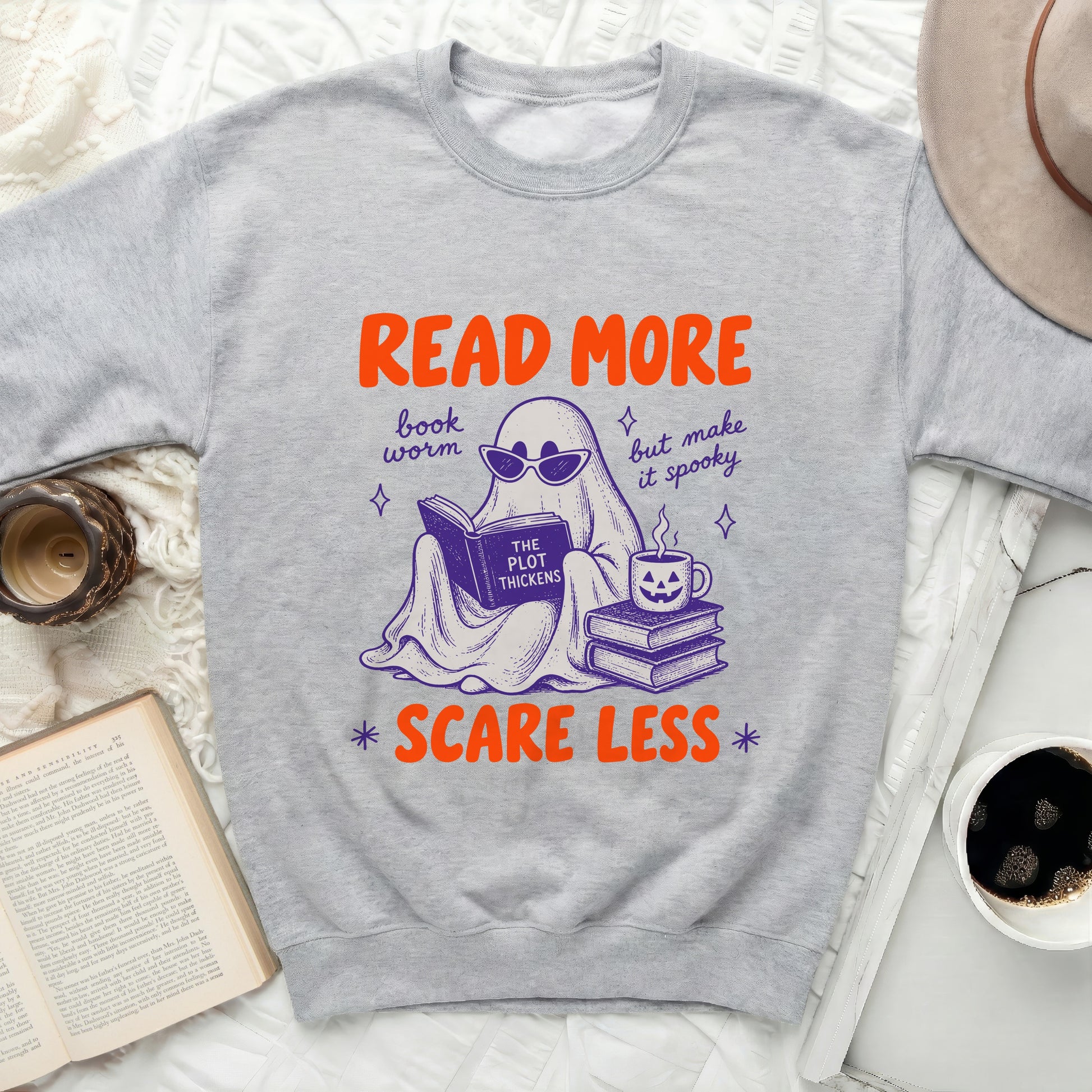Ghost in sunglasses reads a book with text "The Plot Thickens" and "Read More" "Scare Less".