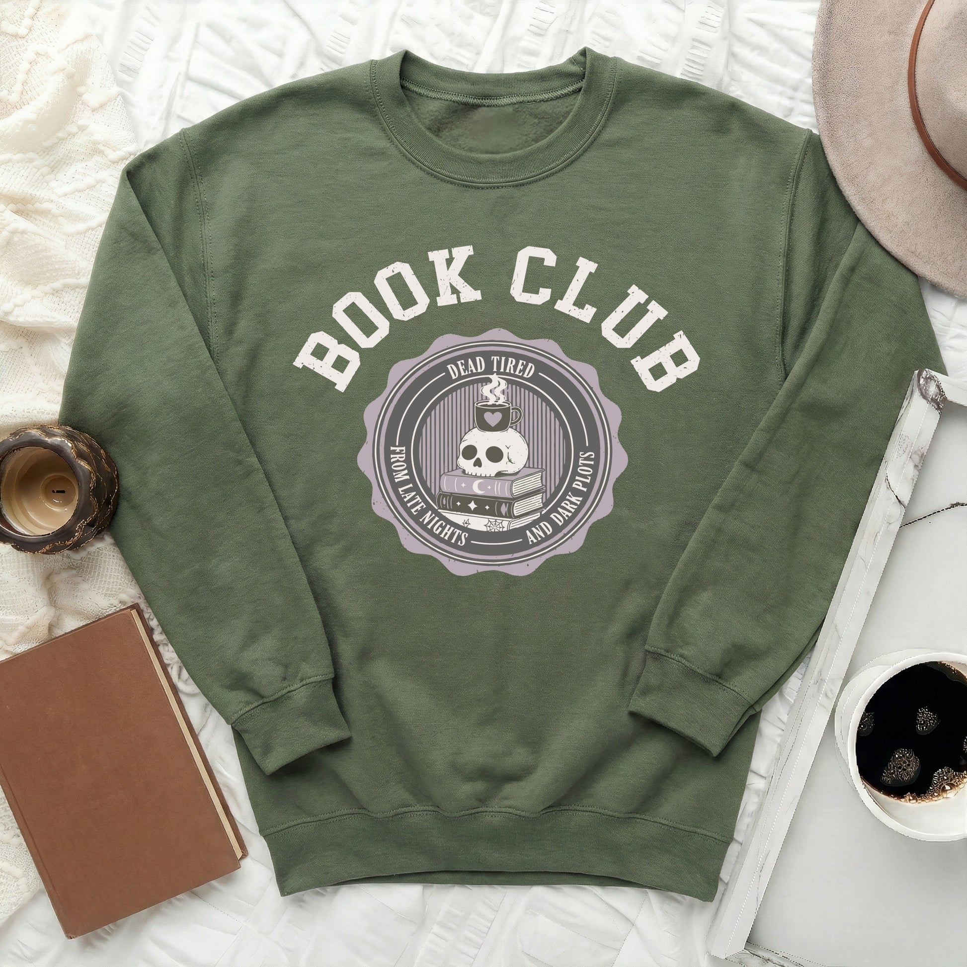 Green sweatshirt with "Book Club" text and skull graphic about reading.