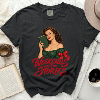 Dark t-shirt with a pin-up illustration and red text reading "Weekends Are For Stories."