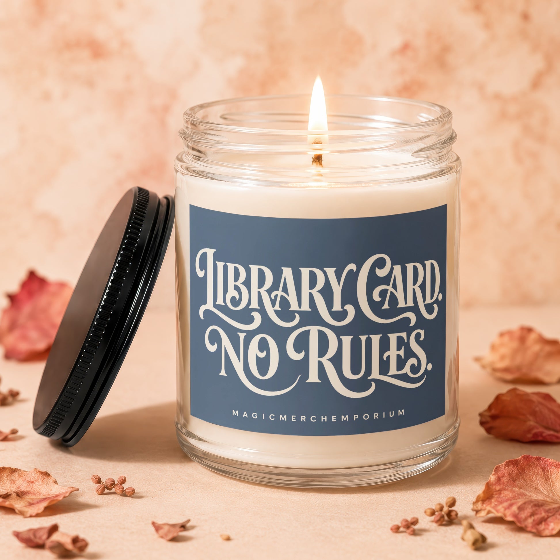 Lit candle in glass jar with "Library Card NO RULES" label and black lid.