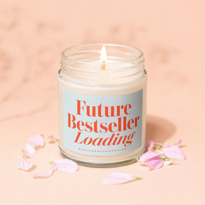 Lit candle in glass jar with "Future Bestseller Loading" text and petals.