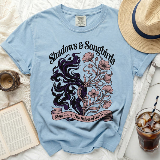 Light blue t-shirt with "Shadows & Songbirds" and floral design.