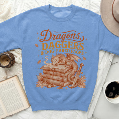 Dragons Daggers & Dog-Eared Pages graphic on blue sweatshirt.