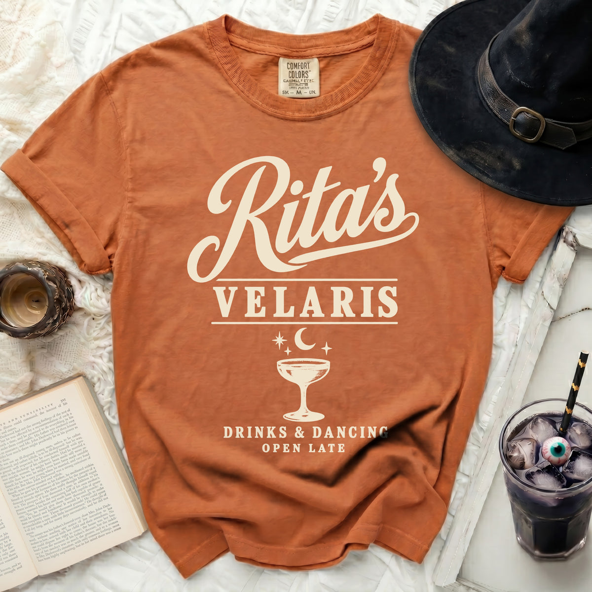 Orange t-shirt with "Rita's Velaris Drinks & Dancing Open Late" text and graphic.