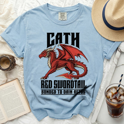 Light blue t-shirt with a red dragon graphic and text "CATH RED SWORDTAIL BONDED TO DAIN AETOS".