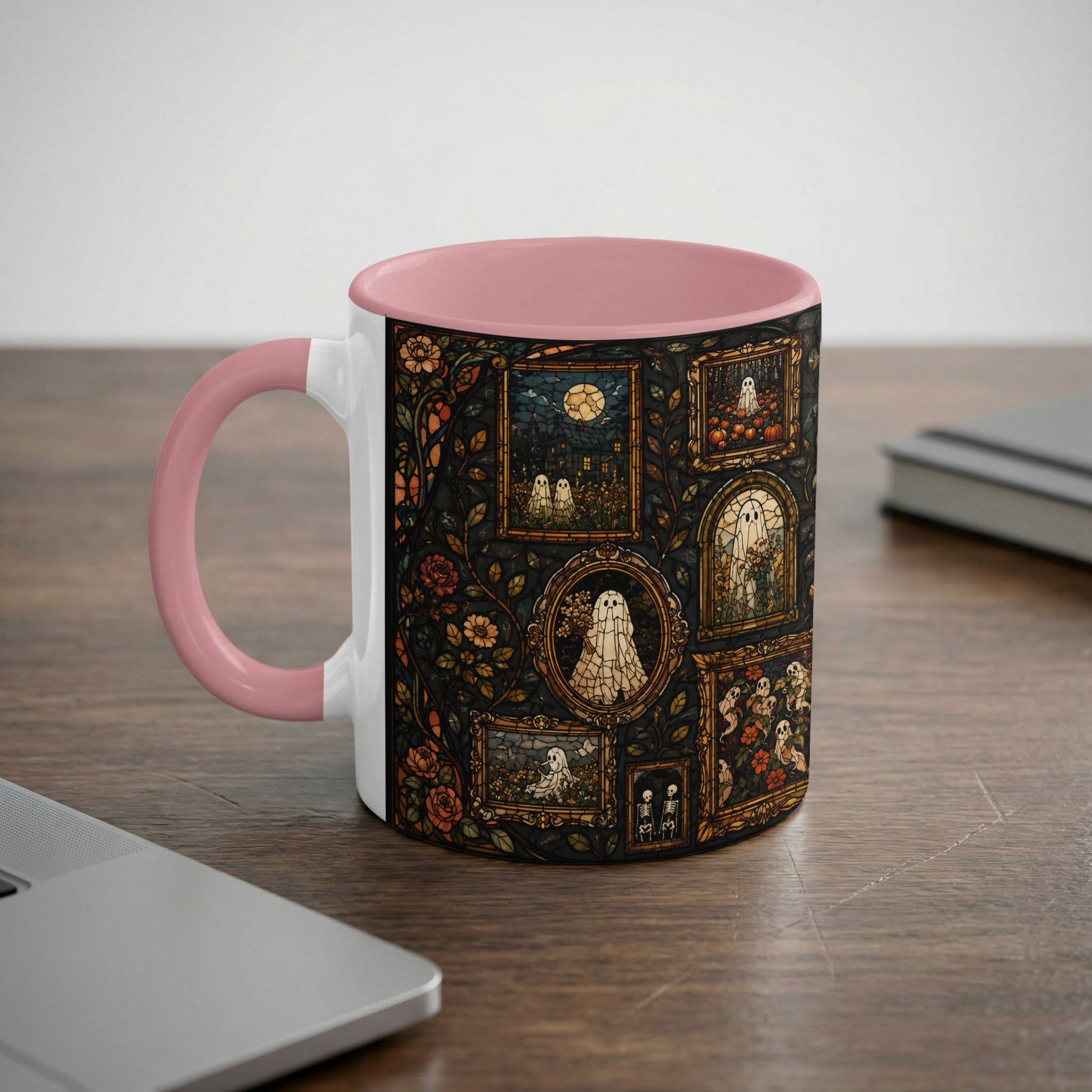 Mug with pink handle featuring framed ghost and pumpkin motifs in stained glass style.