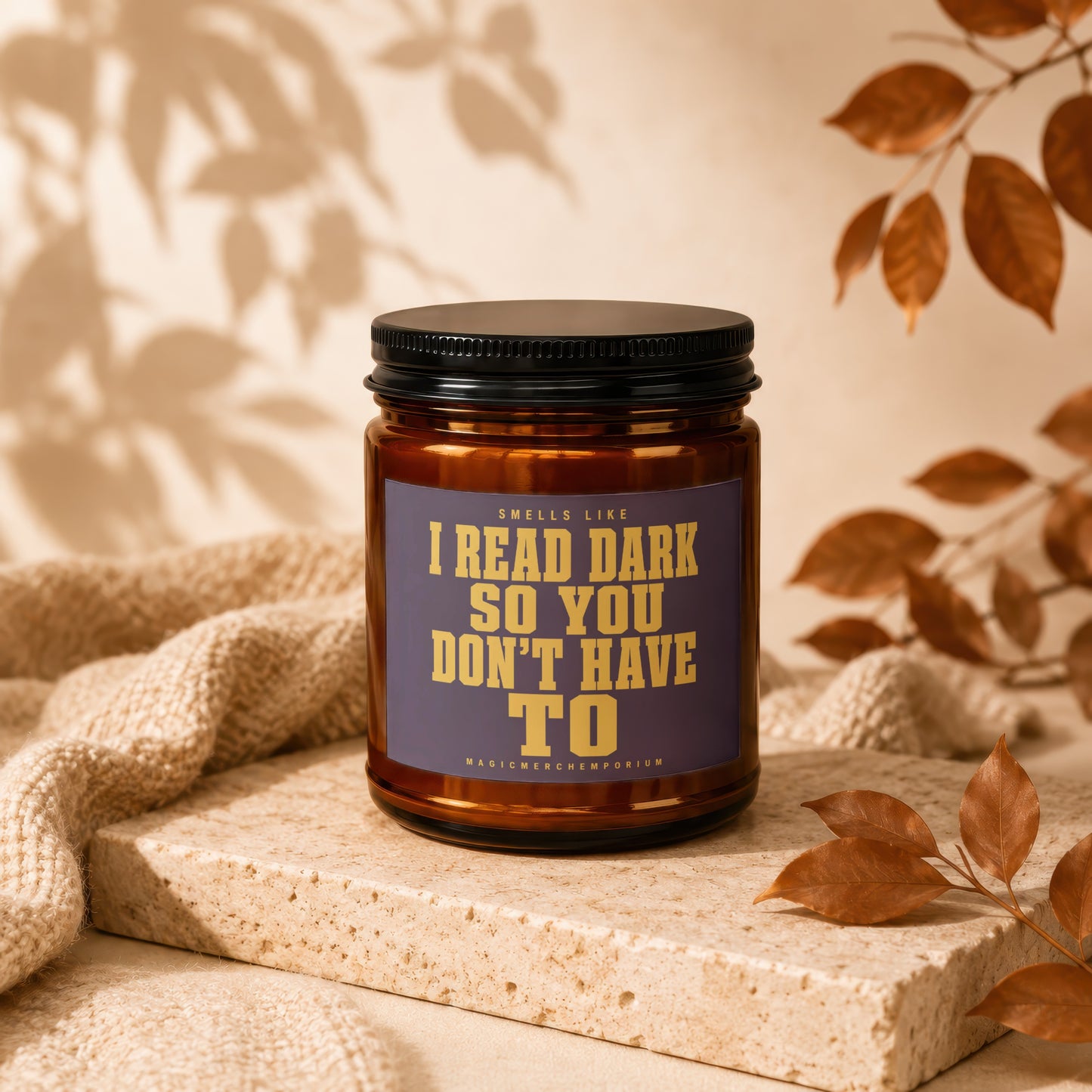 Amber jar candle with text "Smells like I read dark so you don't have to."