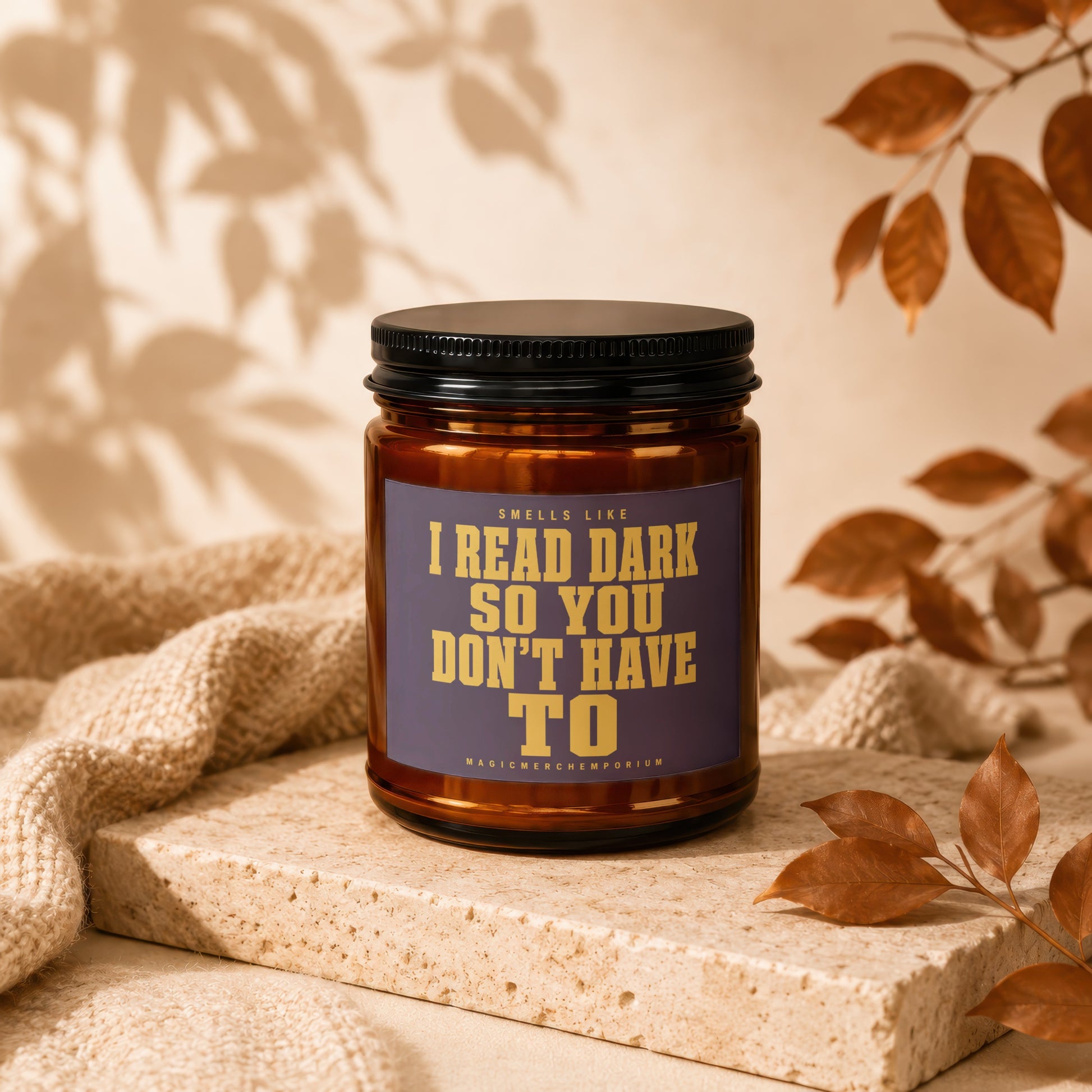 Amber jar candle with text "Smells like I read dark so you don't have to."