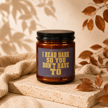 Amber jar candle with text "Smells like I read dark so you don't have to."