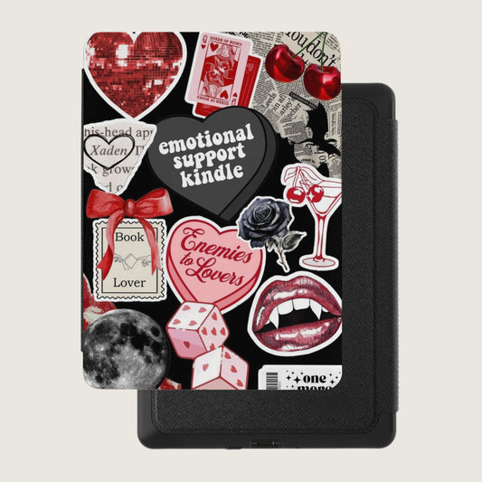 Kindle case with assorted stickers including hearts, dice, lips, and text.