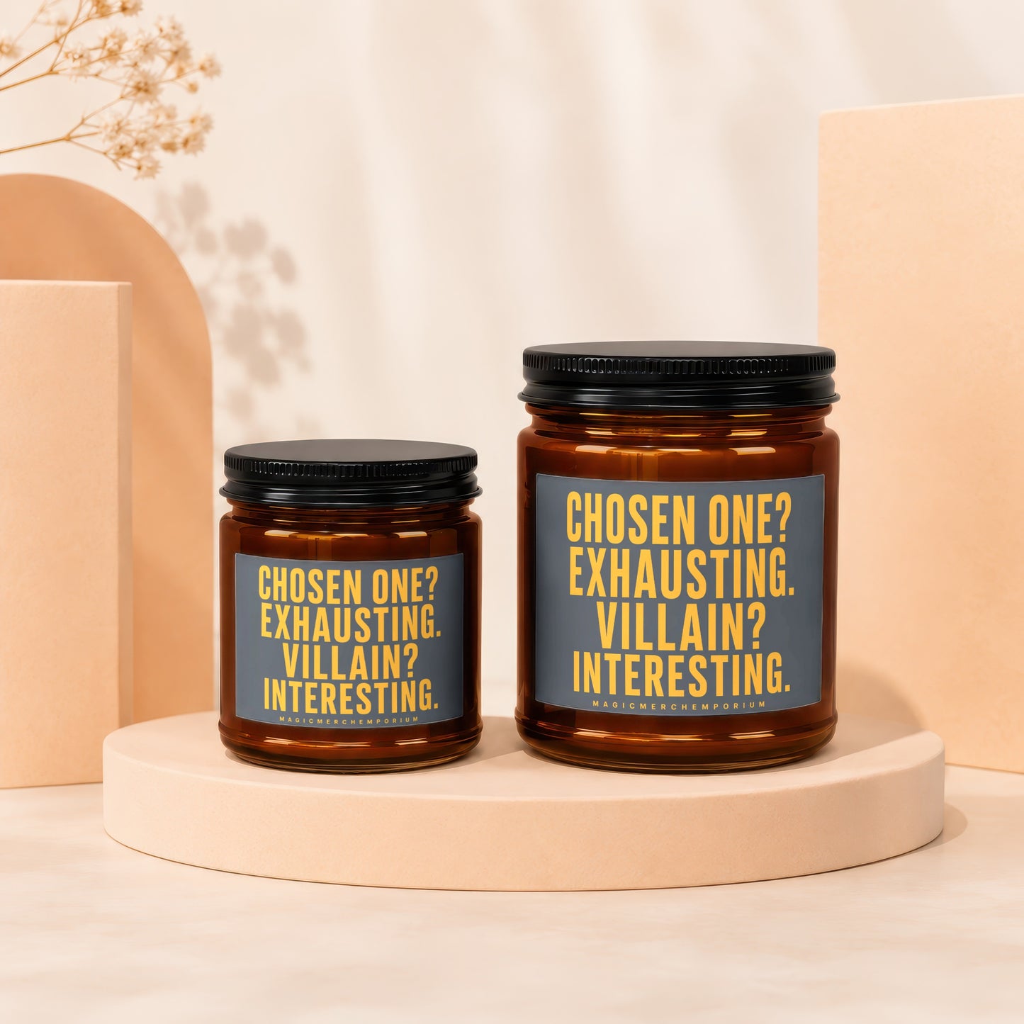 Two amber glass candles with black lids display grey labels with yellow text.