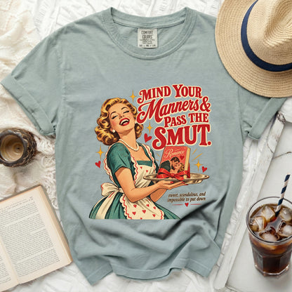 Retro graphic t-shirt with text "Mind Your Manners & Pass the Smut" and vintage woman.
