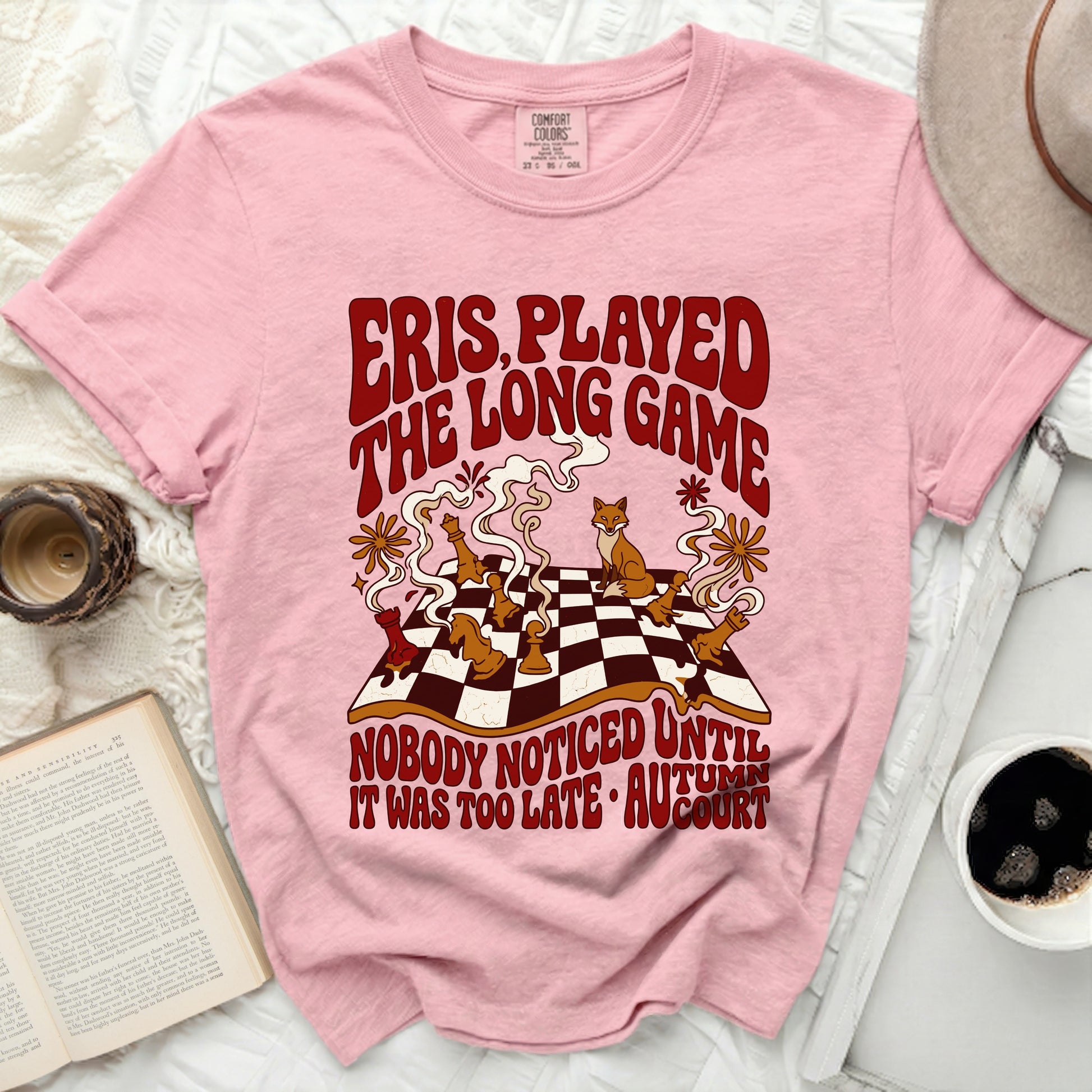 Pink t-shirt with "Eris Played The Long Game Nobody Noticed Until It Was Too Late" text and chess pieces.