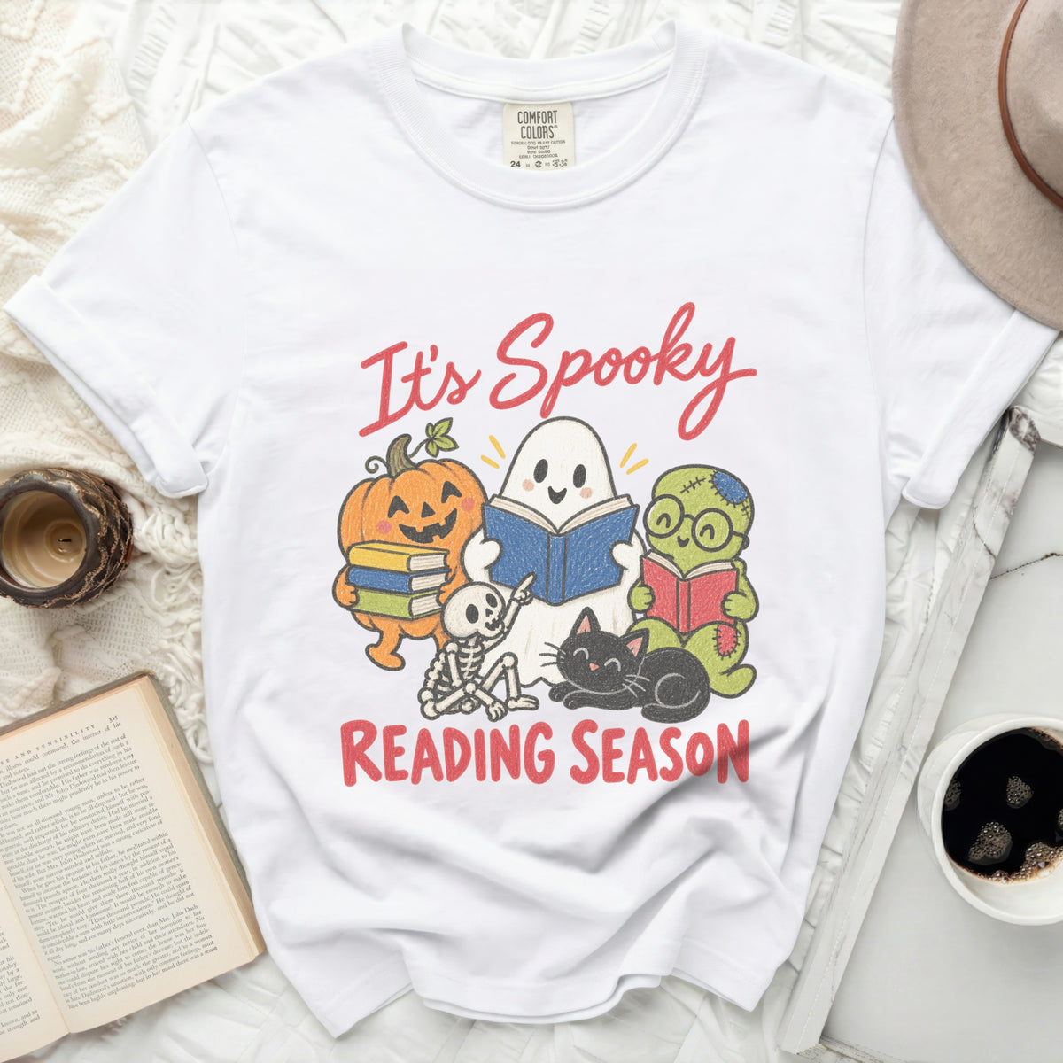 White t-shirt with "It's Spooky Reading Season" and Halloween characters reading books.