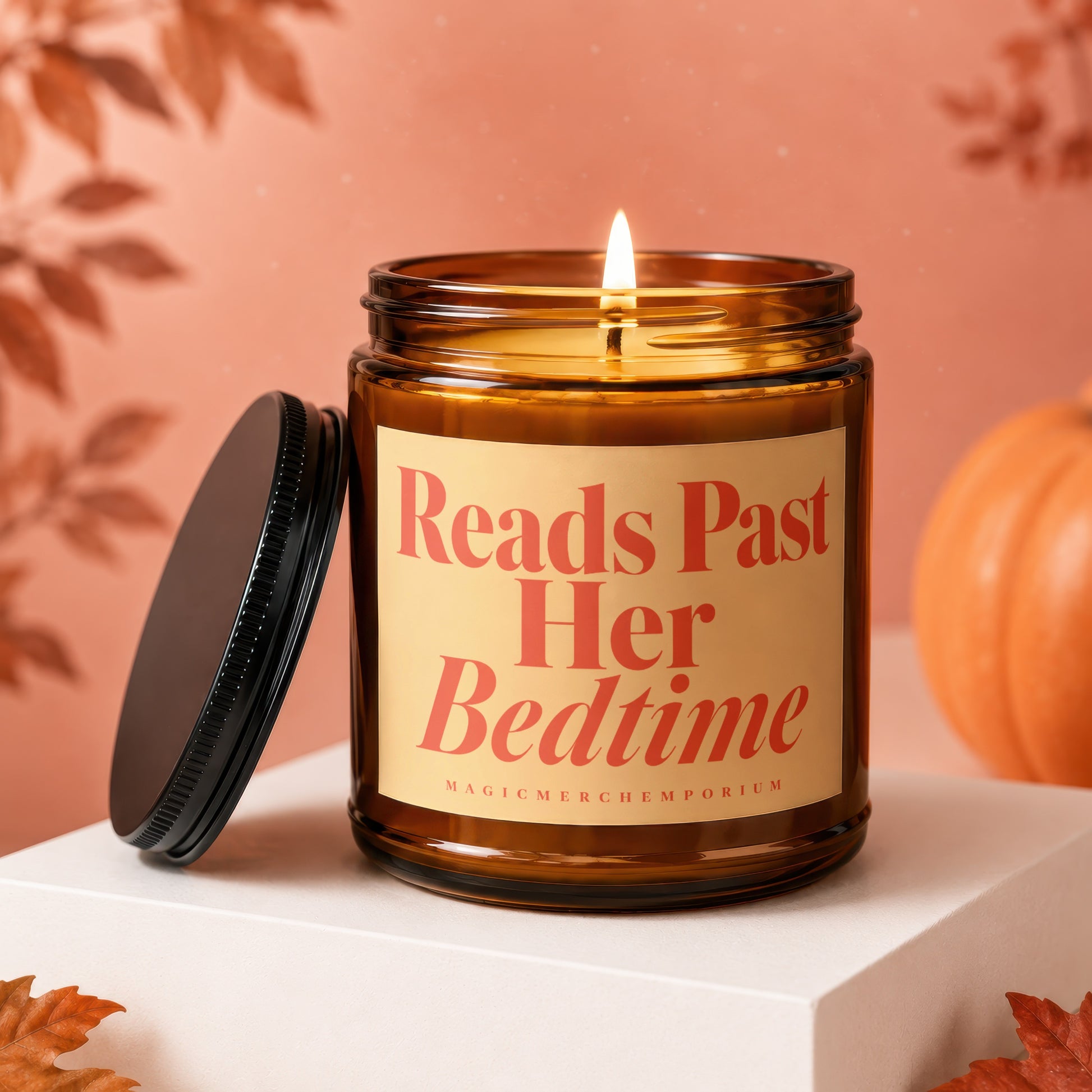 Amber jar candle with "Reads Past Her Bedtime" text and a lit wick.