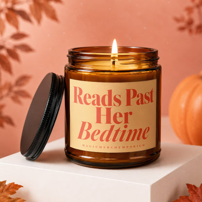 Amber jar candle with "Reads Past Her Bedtime" text and a lit wick.