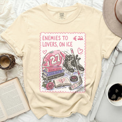 Cream t-shirt with pink ice hockey graphic and text "Enemies to Lovers, on Ice".