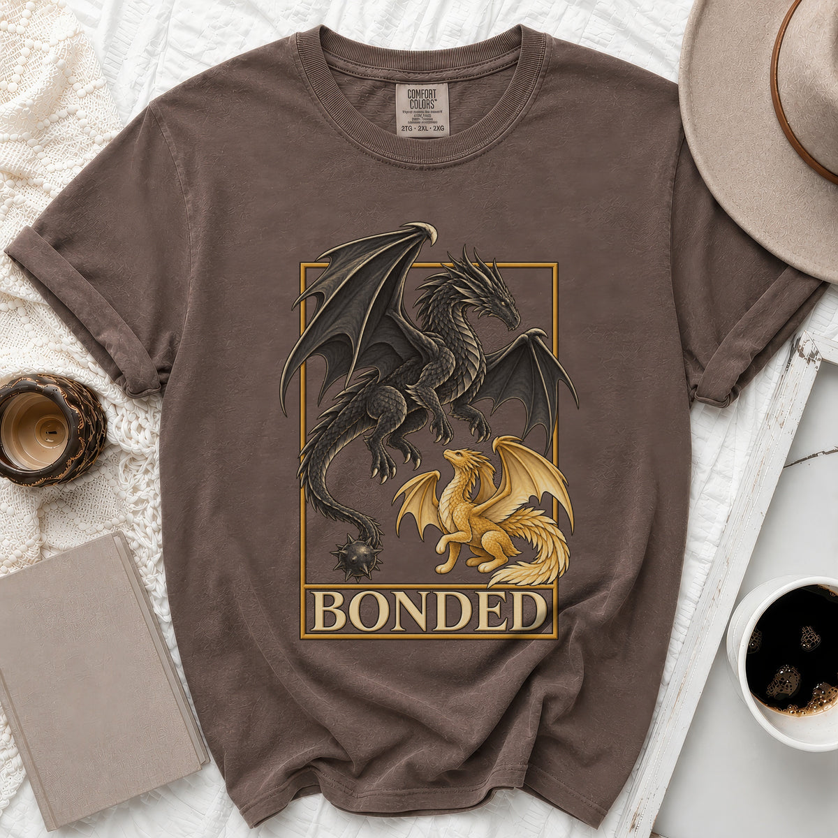 Brown t-shirt with black and gold dragons graphic and text "BONDED."