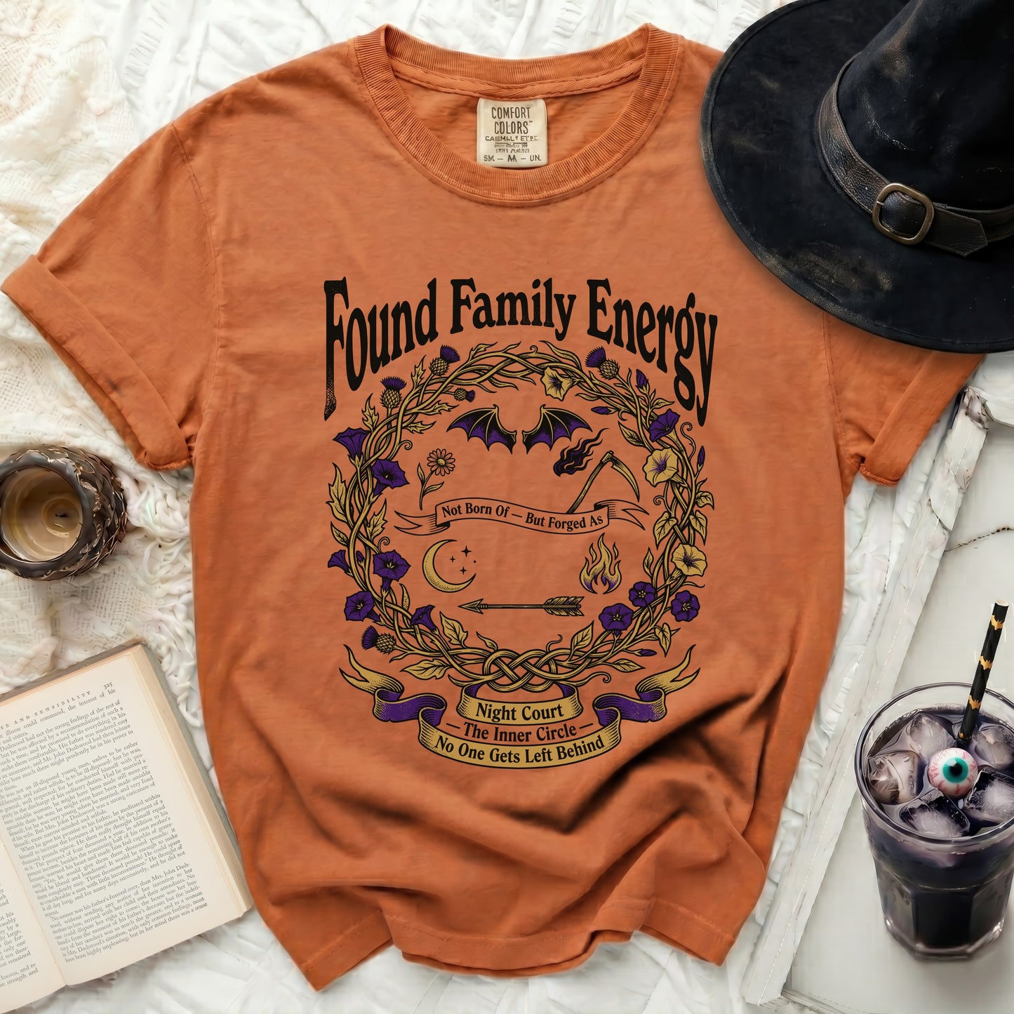 Orange t-shirt with "Found Family Energy Night Court" graphic.