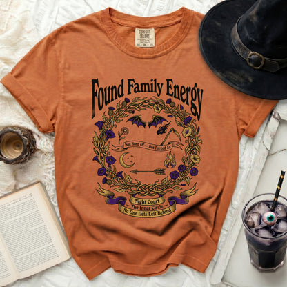 Orange t-shirt with "Found Family Energy Night Court" graphic.