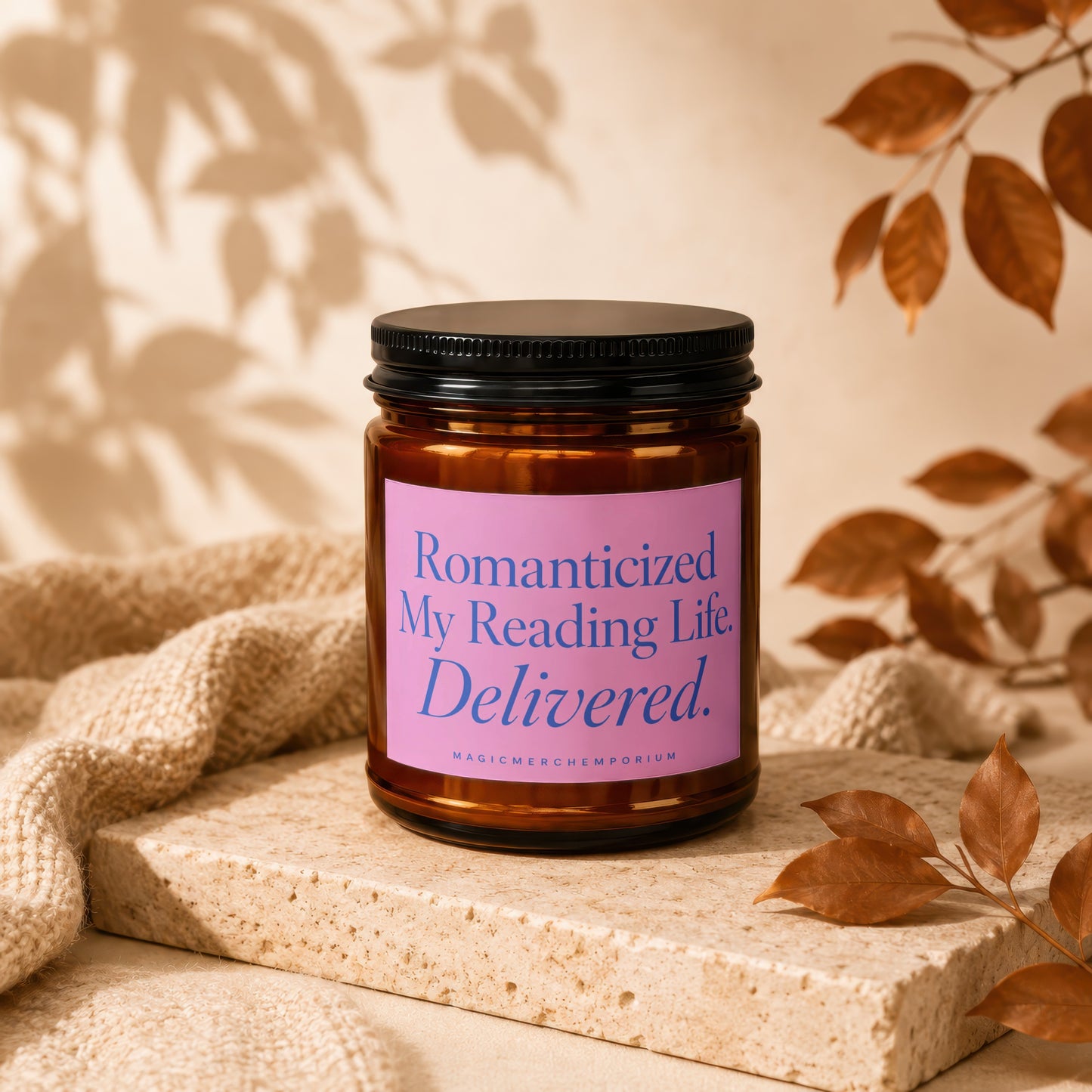 Amber candle with pink label reading "Romanticized My Reading Life. Delivered."