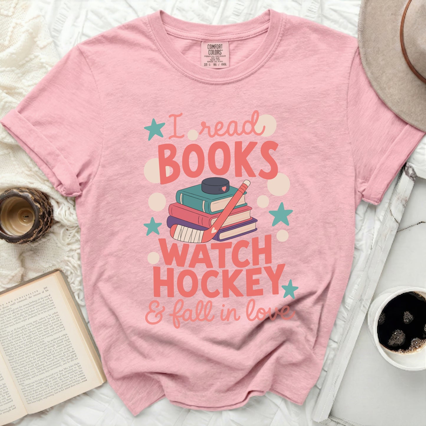 Pink t-shirt with "I read books, watch hockey & fall in love" text.
