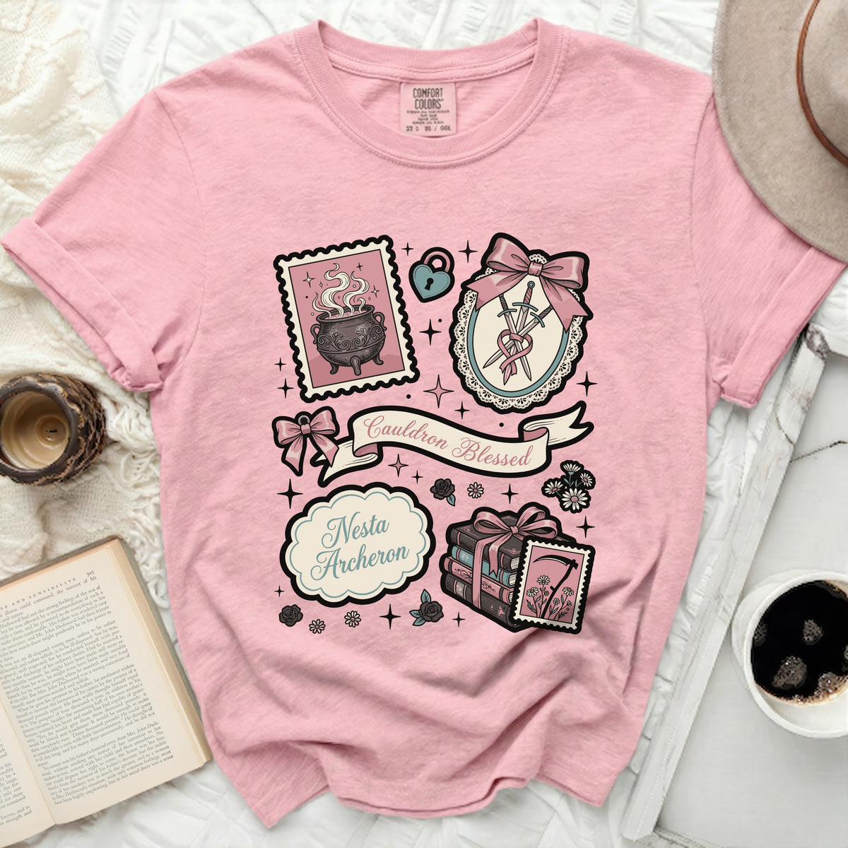Pink t-shirt with "Cauldron Blessed" and "Nesta Archeron" graphic.