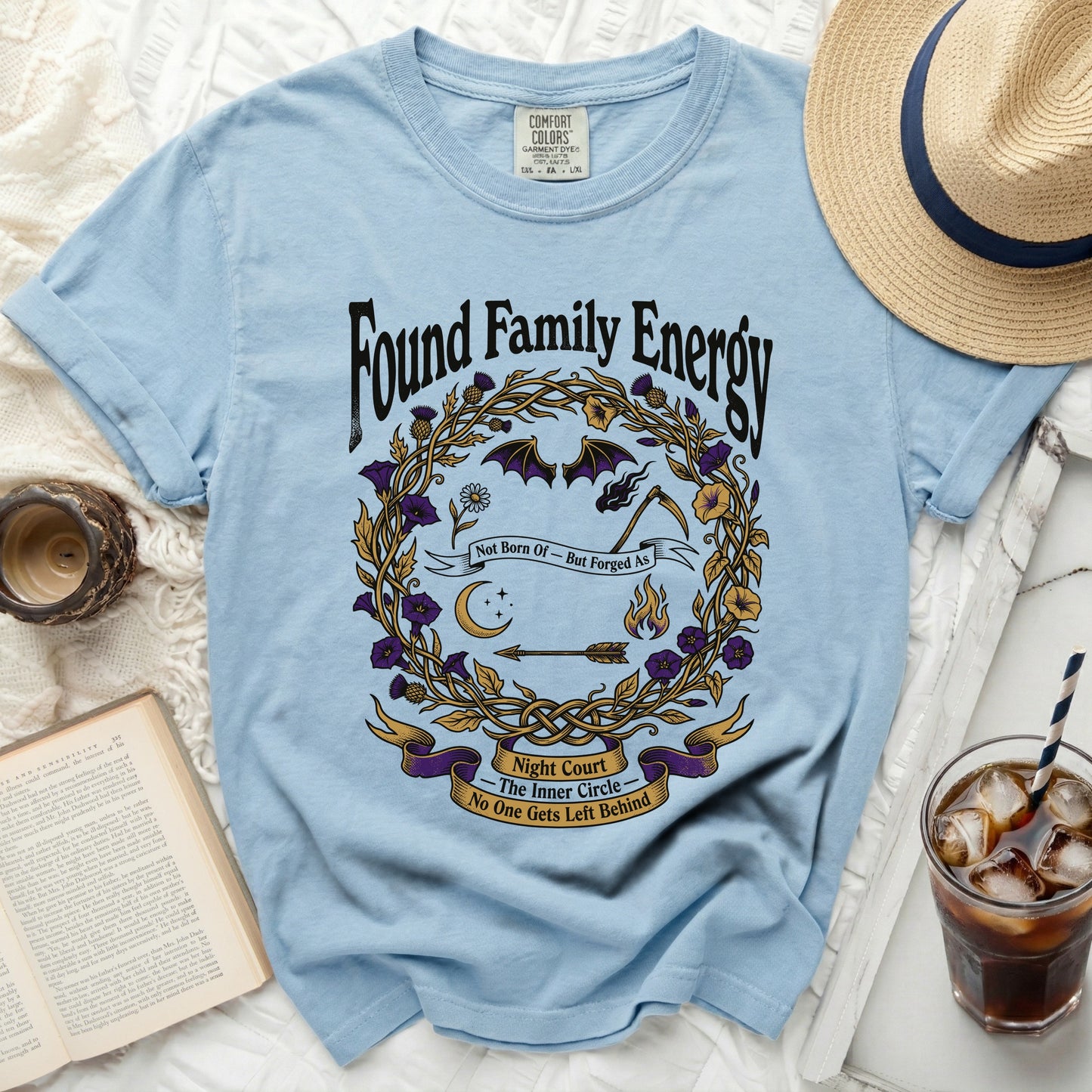 Light blue t-shirt with "Found Family Energy" and graphic design.