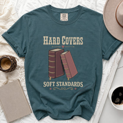 Teal t-shirt with "Hard Covers Soft Standards" text and book graphic.