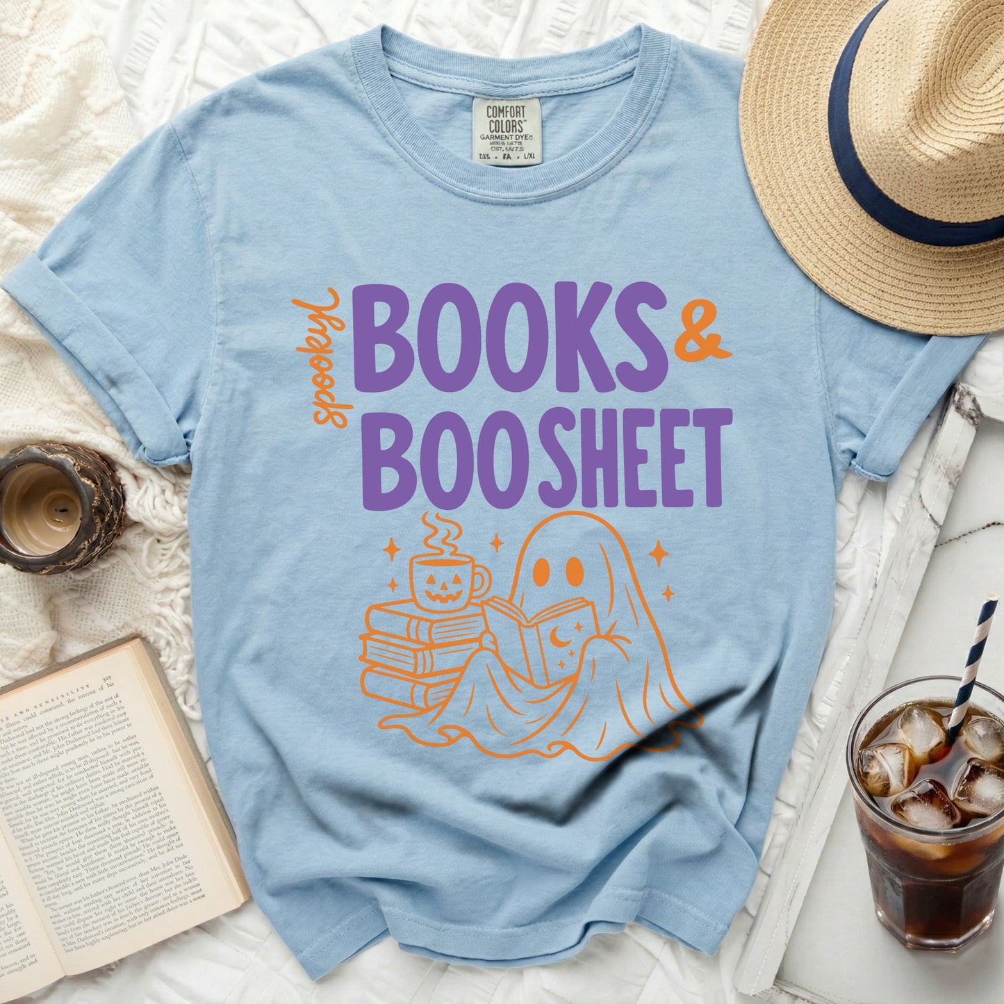 Light blue T-shirt with "spooky BOOKS & BOO SHEET" graphic.
