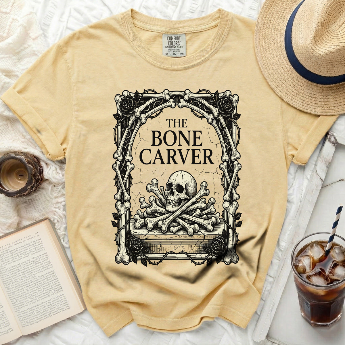 Yellow t-shirt with a skull and crossbones graphic and "The Bone Carver" text.