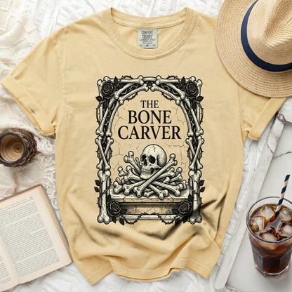 Yellow t-shirt with a skull and crossbones graphic and "The Bone Carver" text.