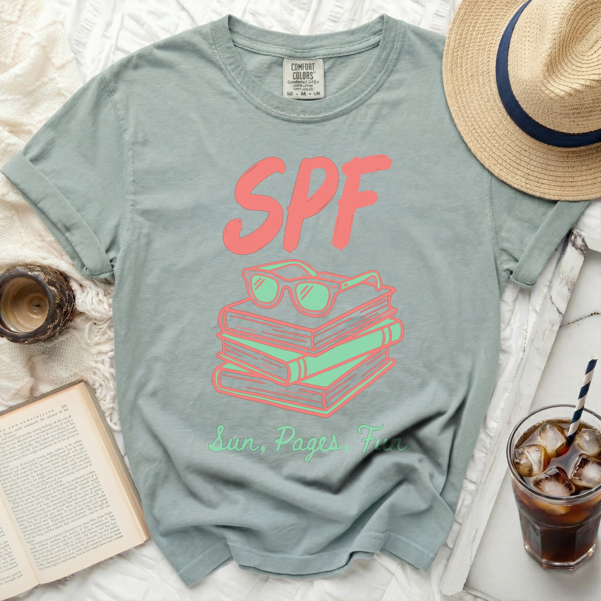 T-shirt with SPF and Sun, Pages Fun graphic on stacked books.