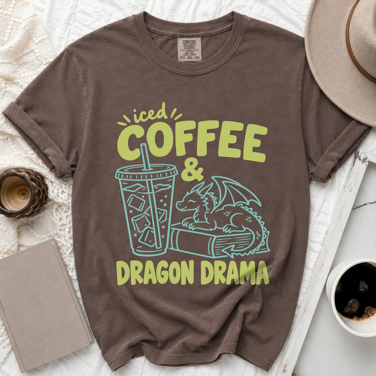 Brown t-shirt with "Iced Coffee & Dragon Drama" graphic and a dragon on a book.
